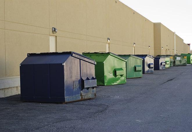 a row of industrial dumpsters at a construction site in Cedar Valley